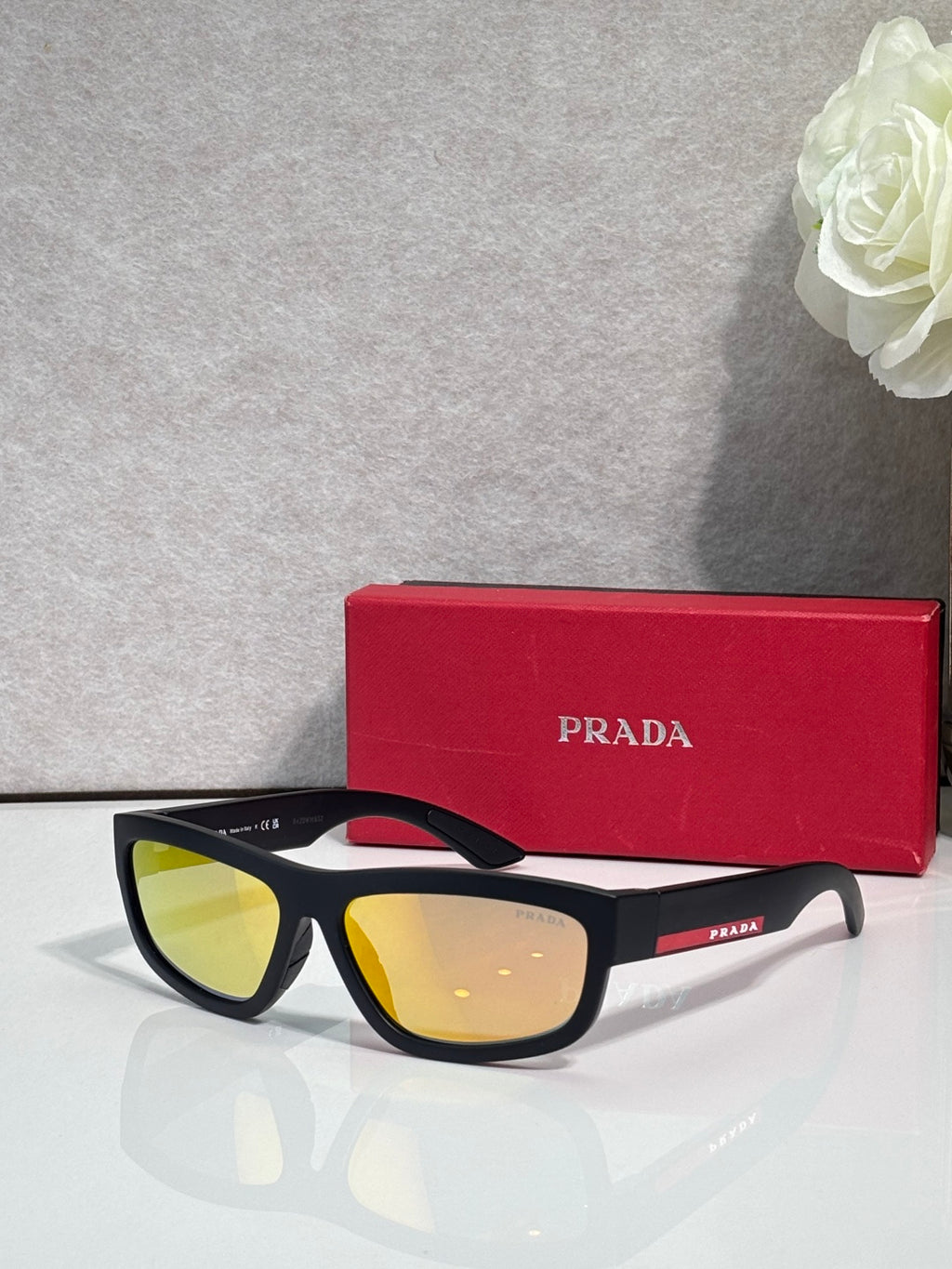 Prada sunglasses with black frames and yellow-tinted lenses