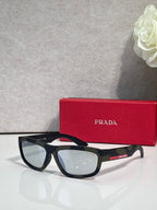 Prada sunglasses with black rectangular frames and light gray tinted lenses