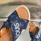 Navy monogram strap close-up on Louis Vuitton slide sandals with tan footbed