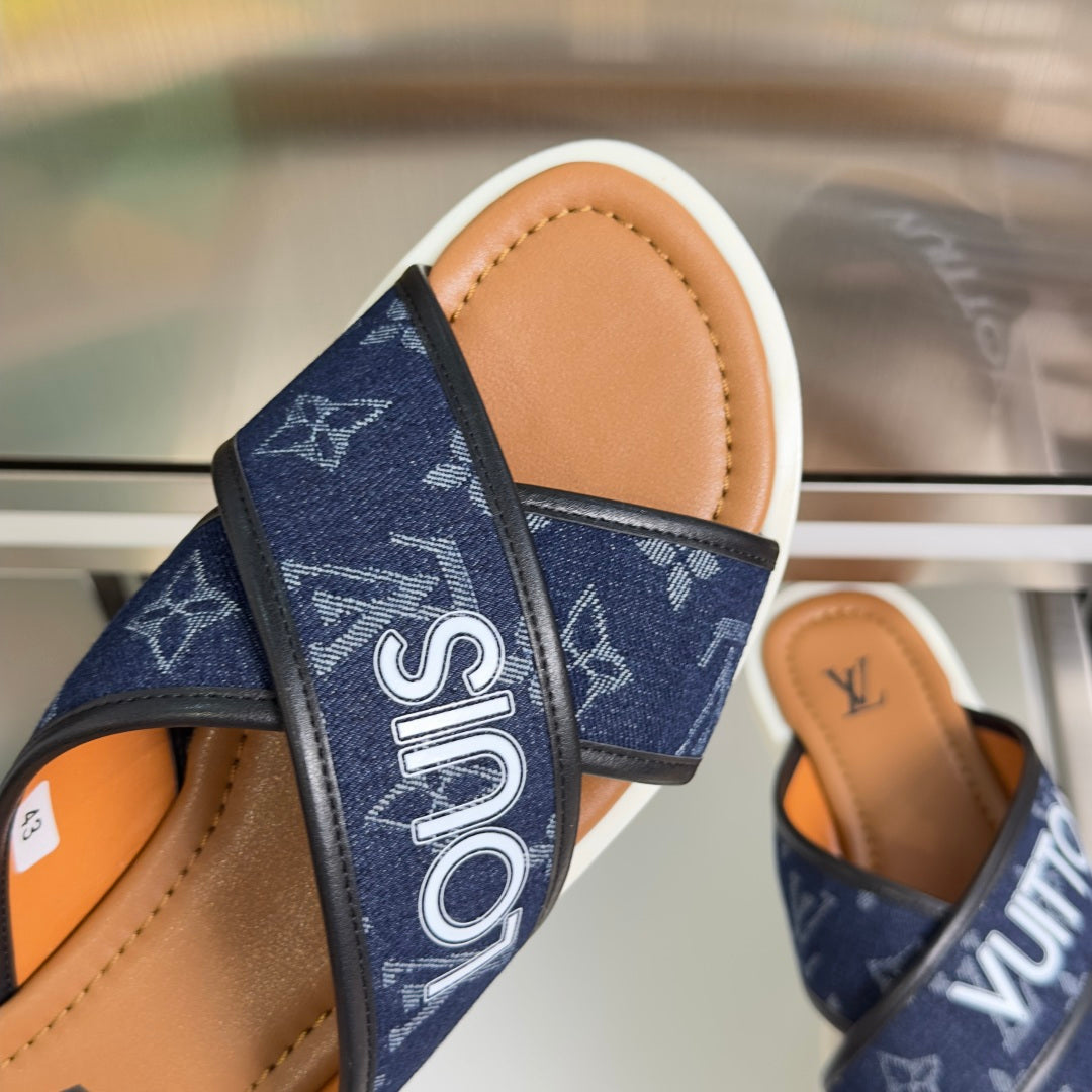 Navy monogram strap close-up on Louis Vuitton slide sandals with tan footbed
