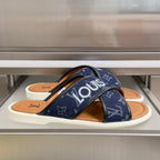 Blue Louis Vuitton slide sandals with monogram straps and tan leather footbed