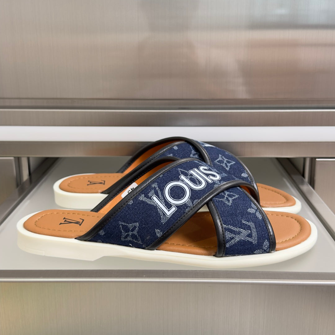 Blue Louis Vuitton slide sandals with monogram straps and tan leather footbed