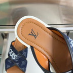 Tan leather footbed of Louis Vuitton slide sandal with navy monogram strap