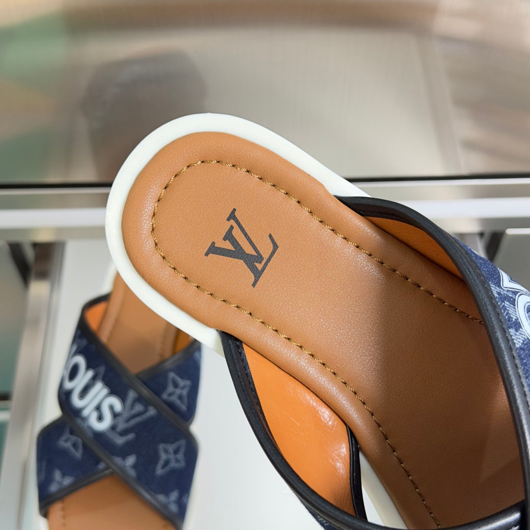 Tan leather footbed of Louis Vuitton slide sandal with navy monogram strap
