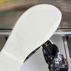 Louis Vuitton slide sandal outsole, white rubber sole with embossed logo text.