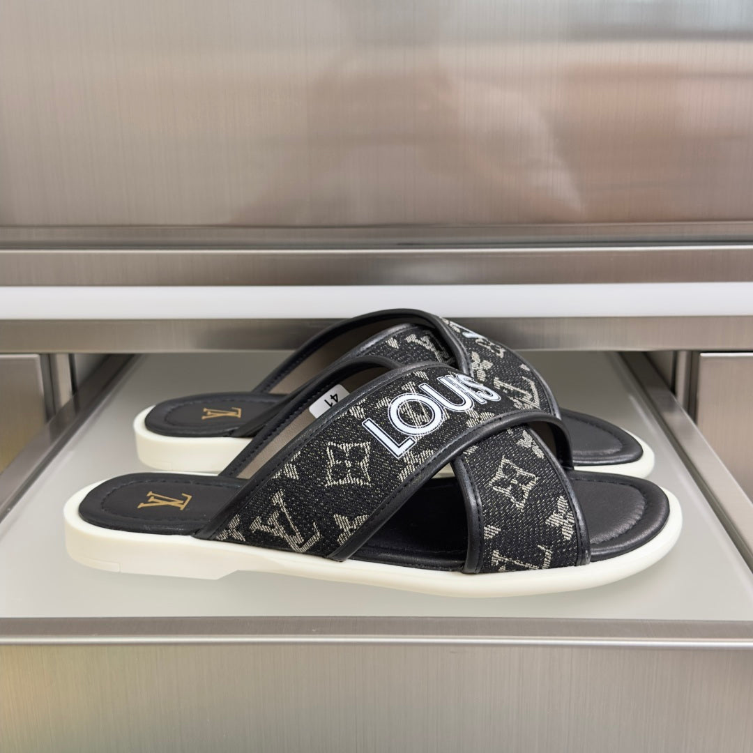 Louis Vuitton slide sandals, black monogram straps and white rubber soles.