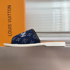 Louis Vuitton slide sandals, navy monogram upper, white sole, tan footbed