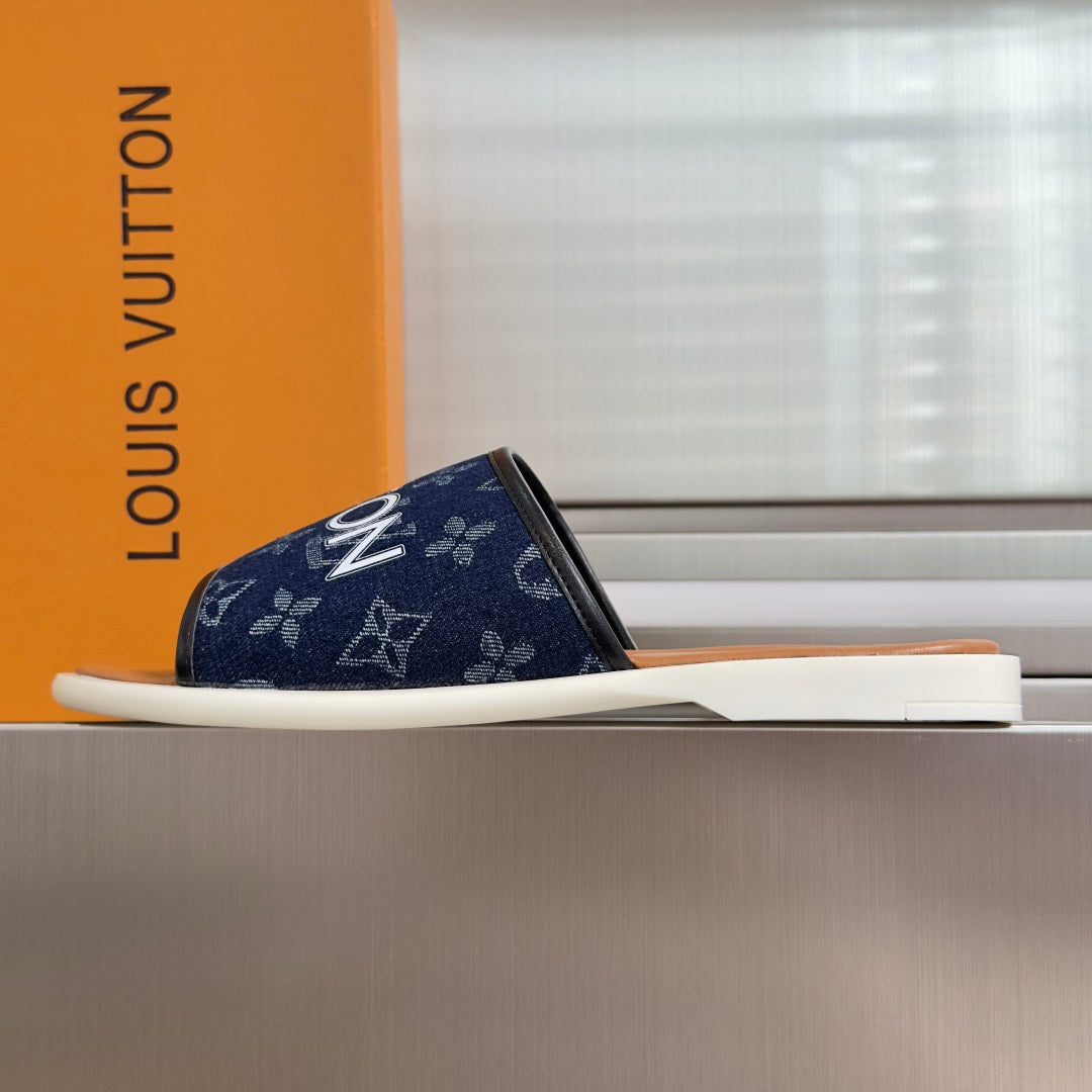Louis Vuitton slide sandals, navy monogram upper, white sole, tan footbed
