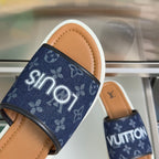 Louis Vuitton slide sandals, navy monogram strap with white lettering, tan footbed