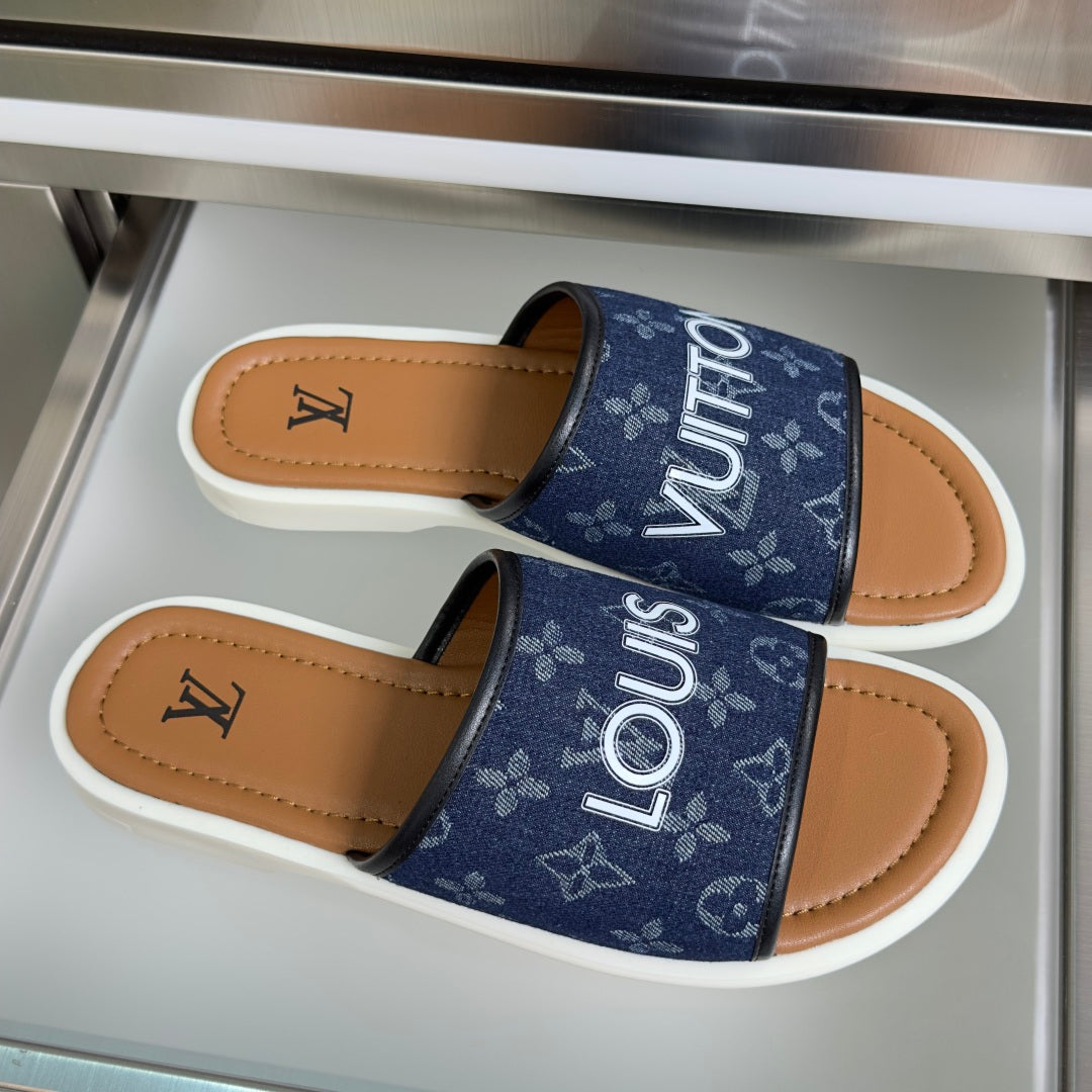 Louis Vuitton slide sandals, navy monogram straps, tan footbed, white sole