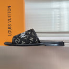 Louis Vuitton monogram slide sandals with black rubber sole and wide front strap