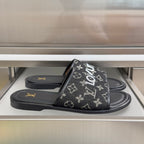 Louis Vuitton monogram slide sandals in black with wide front strap and flat sole