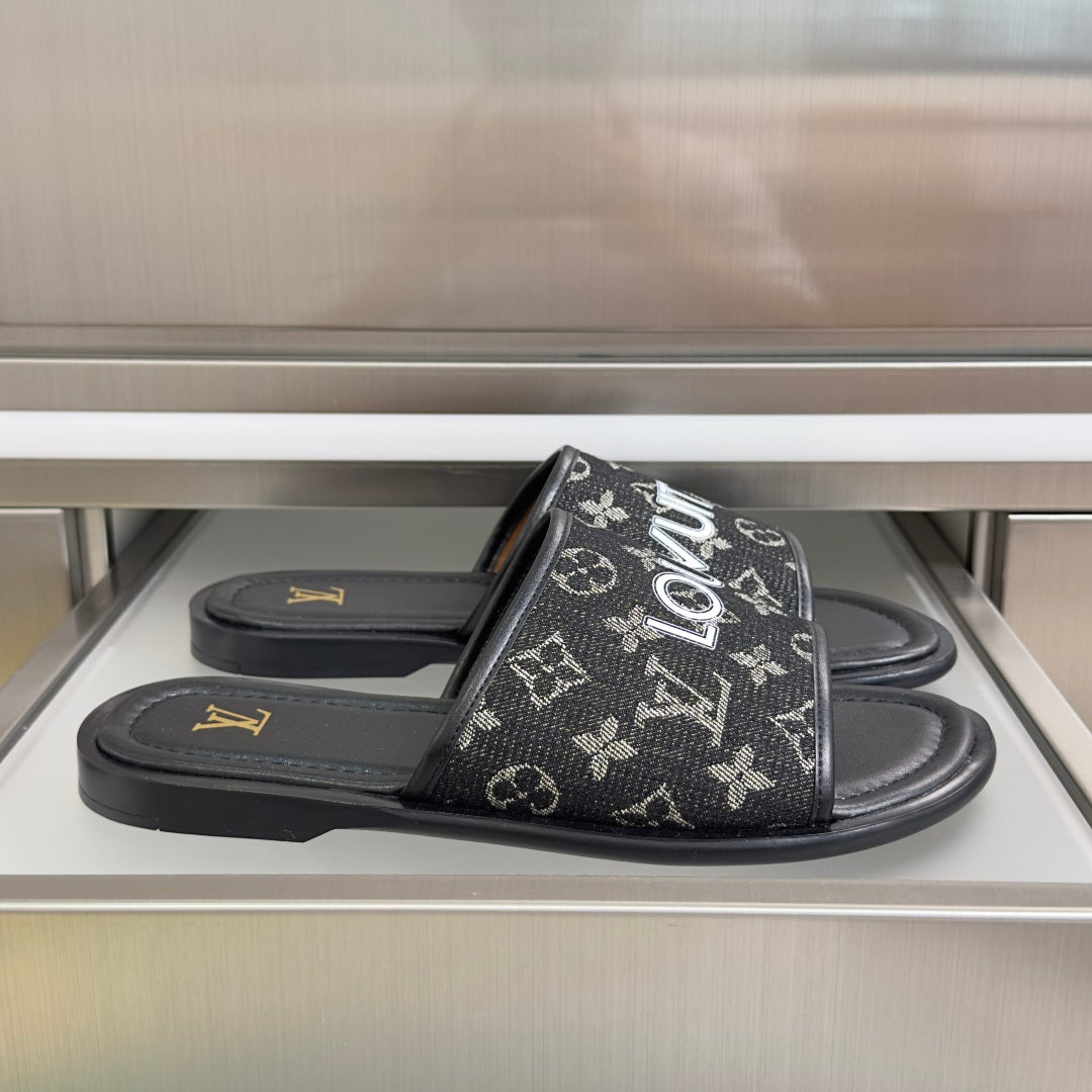 Louis Vuitton monogram slide sandals in black with wide front strap and flat sole