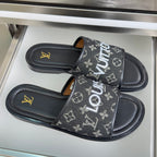 Louis Vuitton monogram slide sandals, black straps with LV-style logos and flat sole