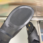 Louis Vuitton black leather slide sandal outsole with embossed Louis Vuitton Paris text