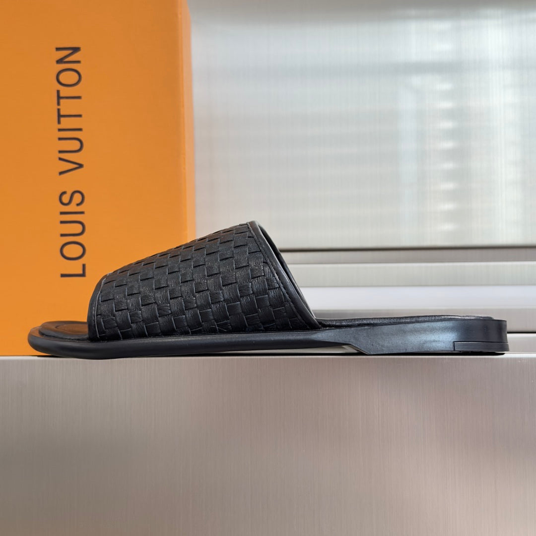 Black woven leather slide sandals with flat wide foot strap