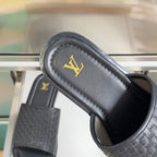 Black woven leather slide sandal with gold LV logo on footbed