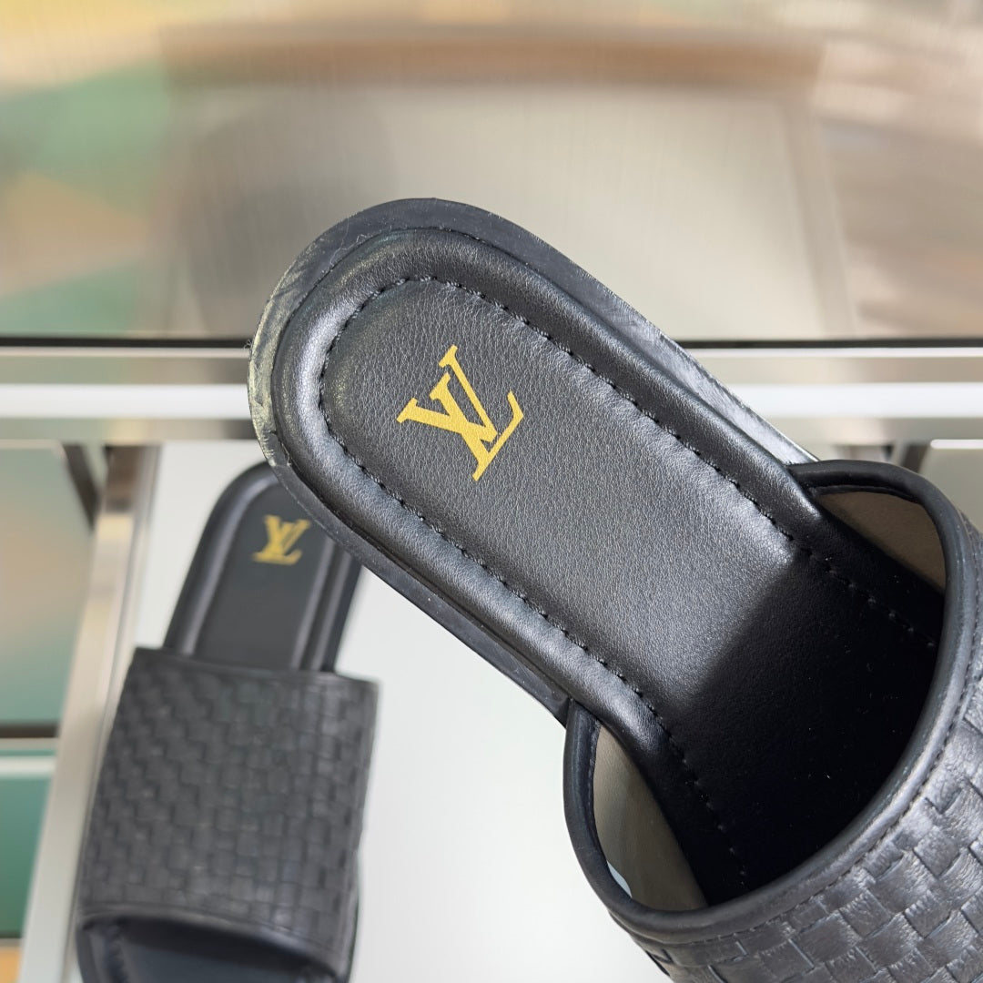 Black woven leather slide sandal with gold LV logo on footbed