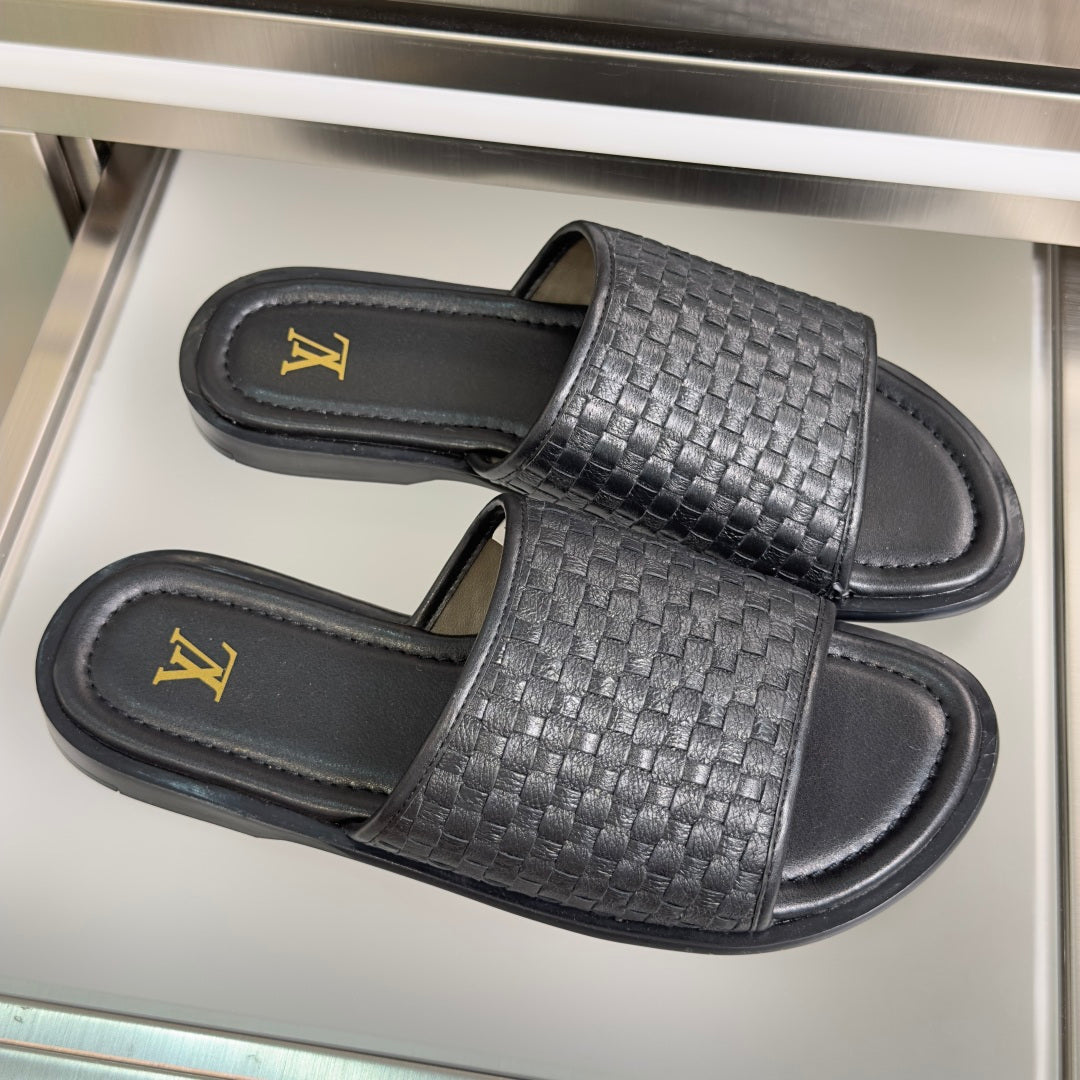 Black woven leather slide sandals with Louis Vuitton gold logo on footbeds