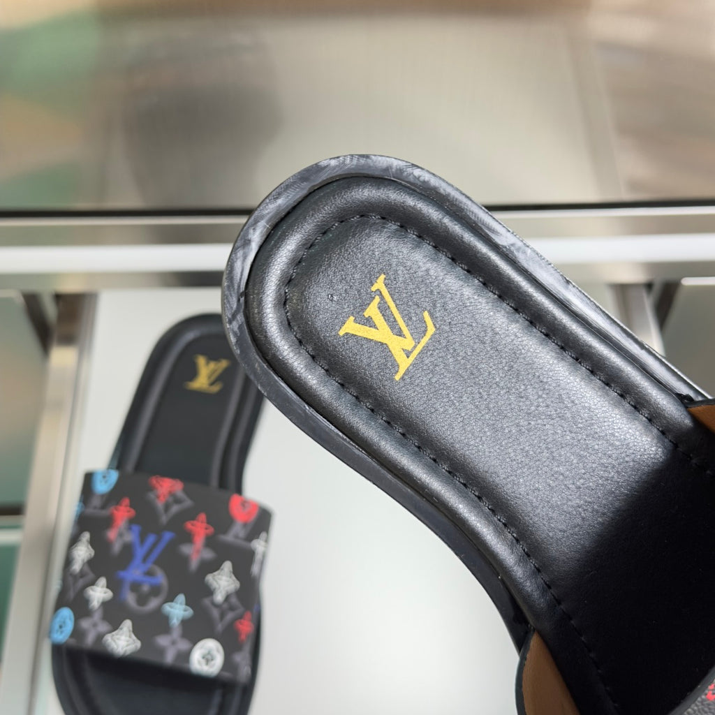 Louis Vuitton slide sandal insole close-up with gold logo on dark leather