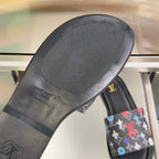 Louis Vuitton slide sandal outsole and footbed close-up with black sole and gold logo