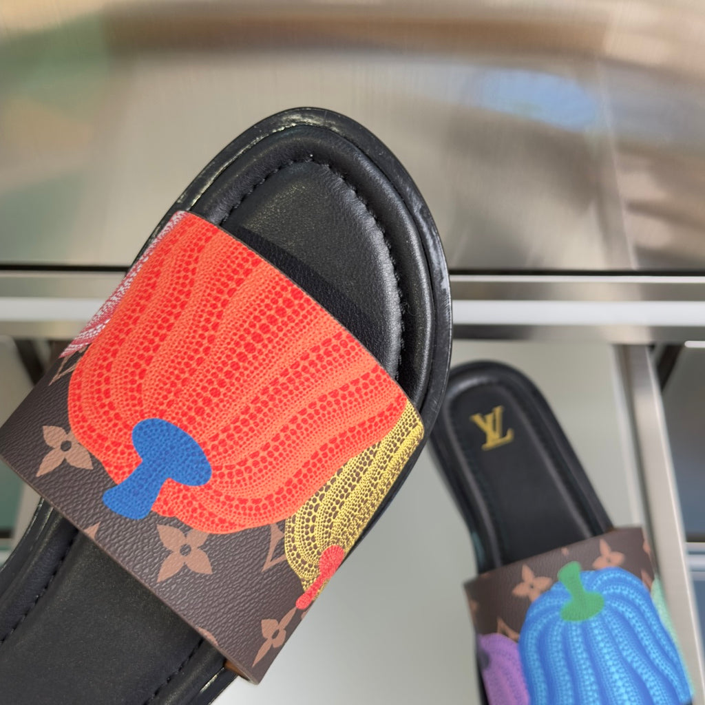 Louis Vuitton slide sandal with red and blue textured strap on dark brown base