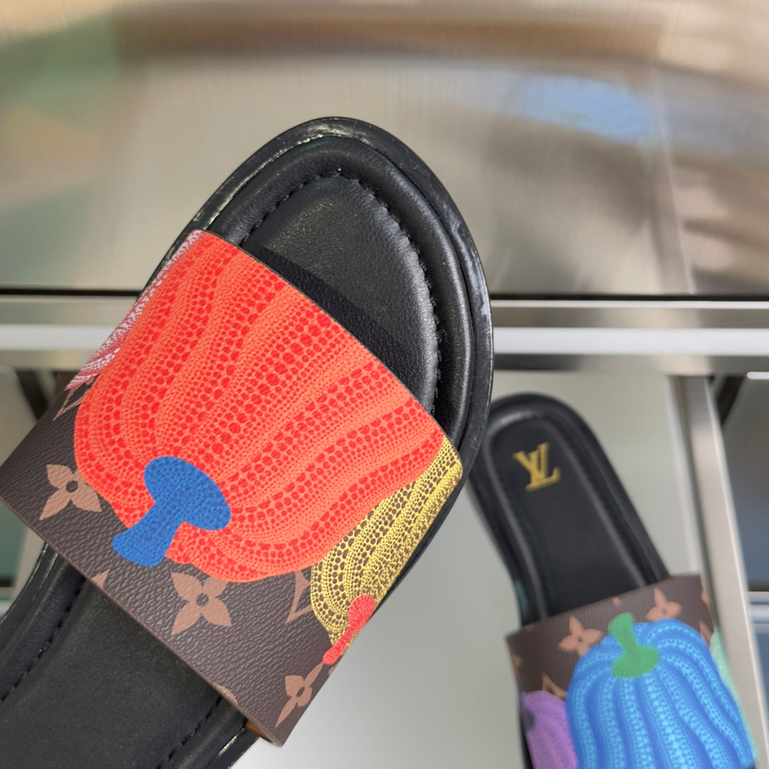 Louis Vuitton slide sandal with red and blue textured strap on dark brown base