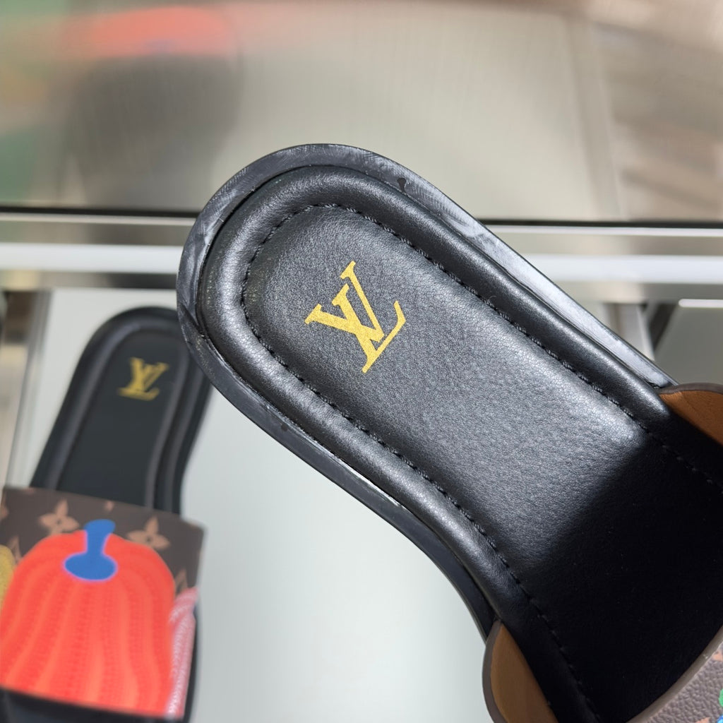 Louis Vuitton sandal strap close-up with gold LV logo on black leather lining