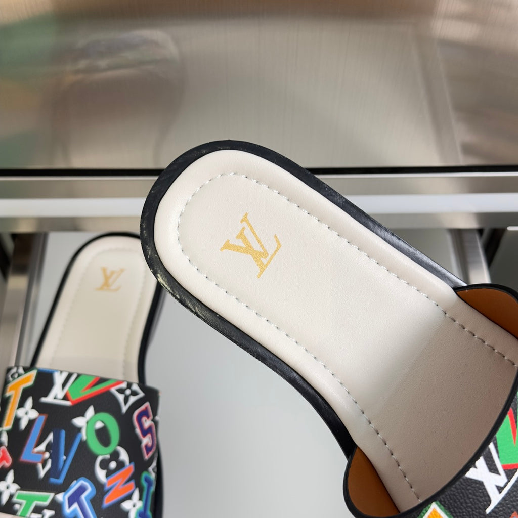 Louis Vuitton slide sandal strap close-up with black trim and white footbed