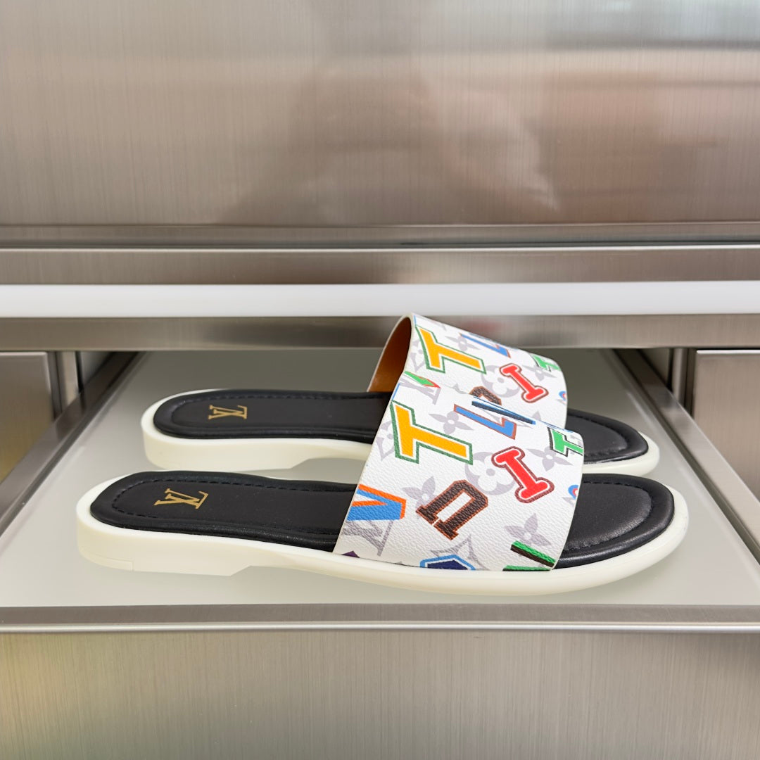 Black slide sandals with multicolor monogram strap and gold LV logo