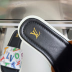 Black slide sandal strap with white trim and gold LV logo