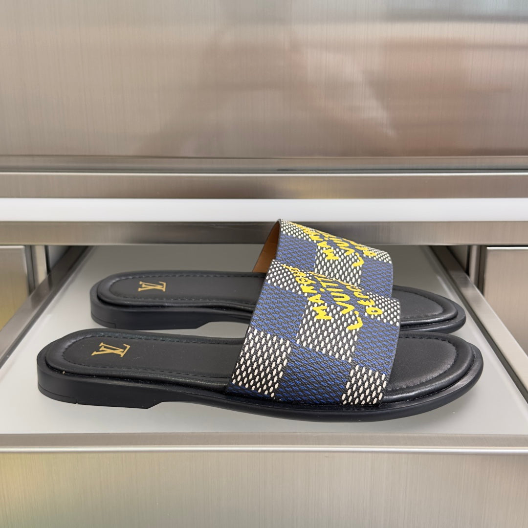 Louis Vuitton slide sandals with black footbed and blue check strap with yellow accents