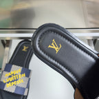 Louis Vuitton sandal strap close-up on black leather with gold LV logo