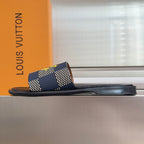 Louis Vuitton slide sandal, side view, black sole with blue check strap and yellow logo