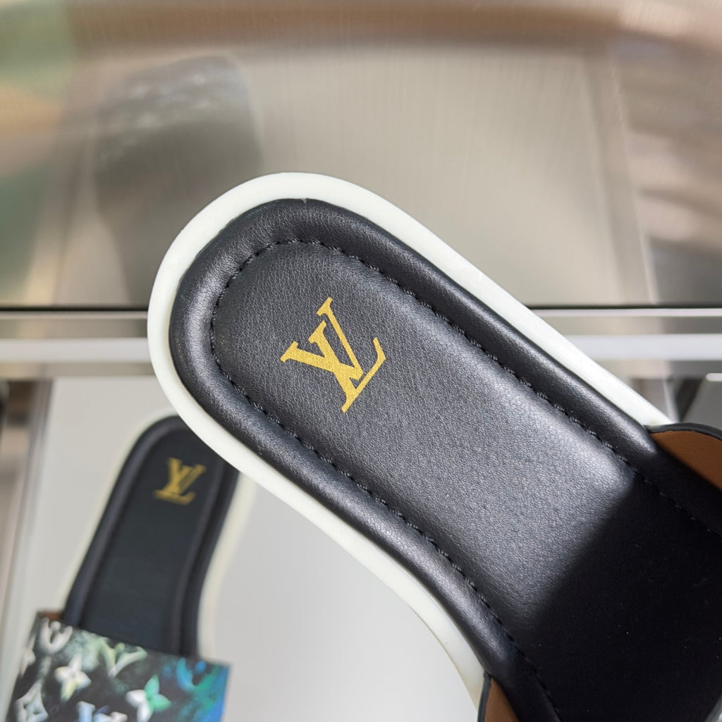 Louis Vuitton sandal strap close-up, black leather with gold LV logo on cushioned lining