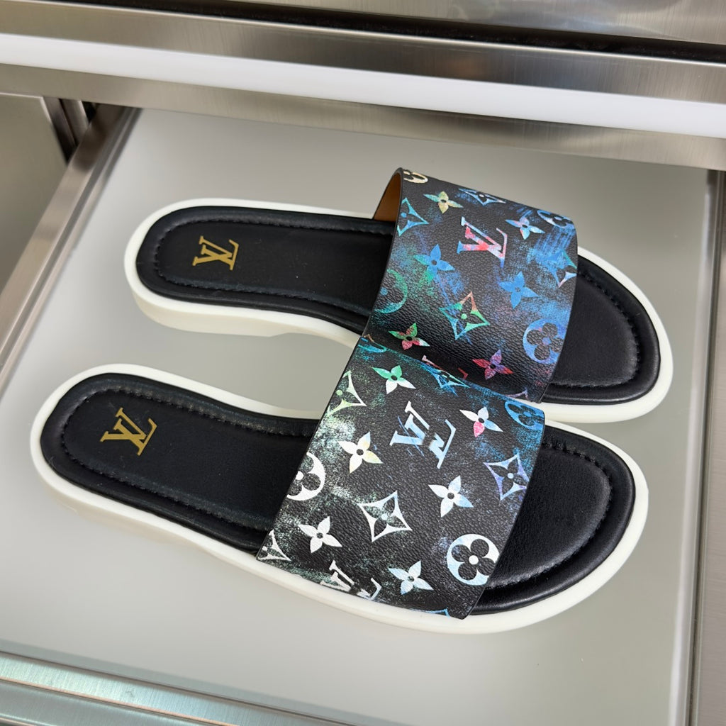 Louis Vuitton slide sandals with black footbed, multicolor logo print, and white sole
