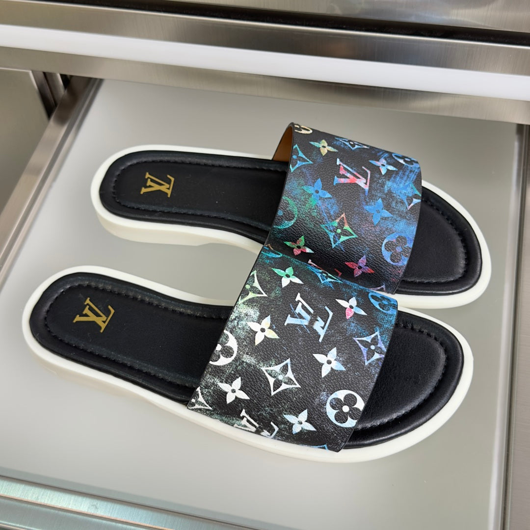 Louis Vuitton slide sandals with black footbed, multicolor logo print, and white sole