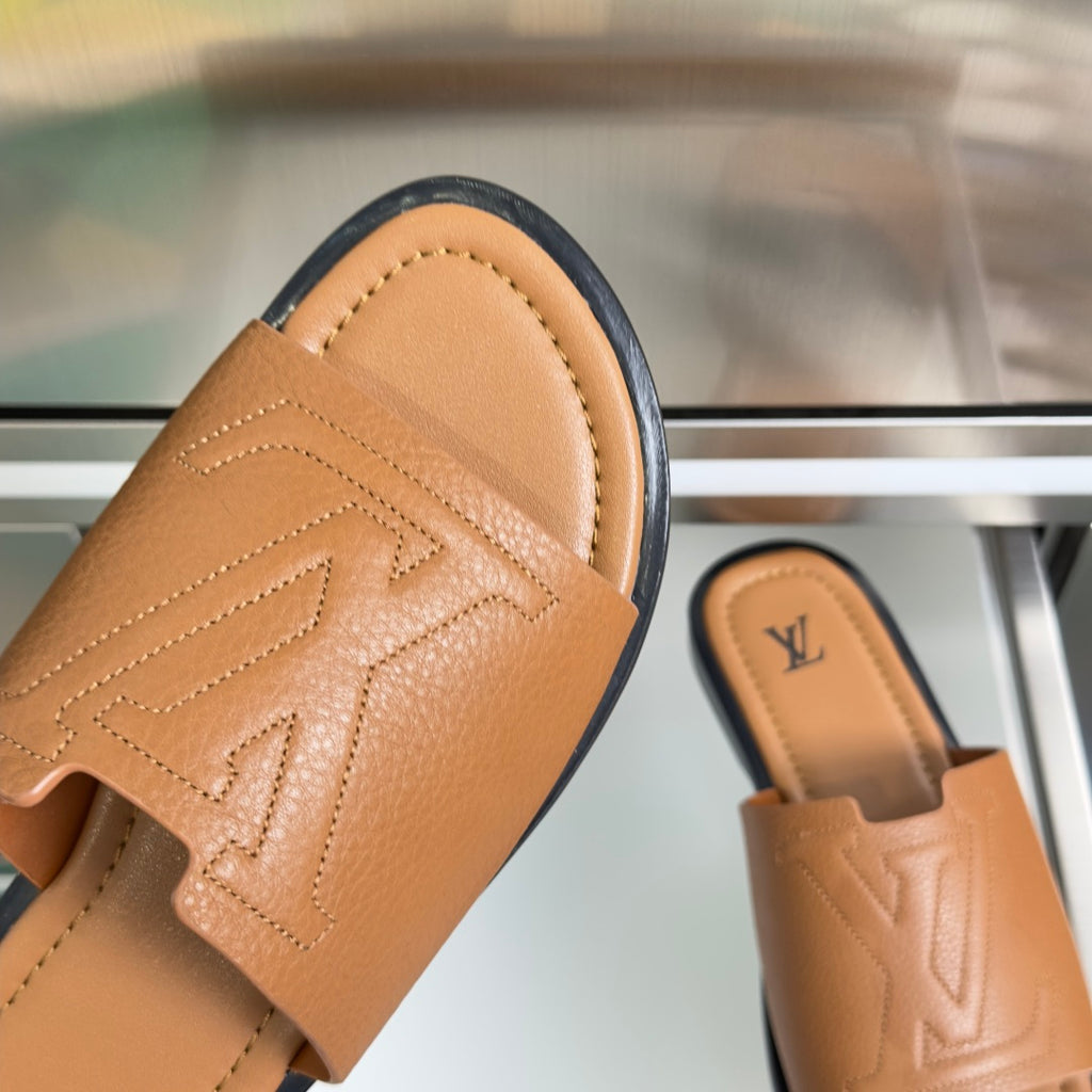 Tan leather slide sandal with patterned LV monogram on strap