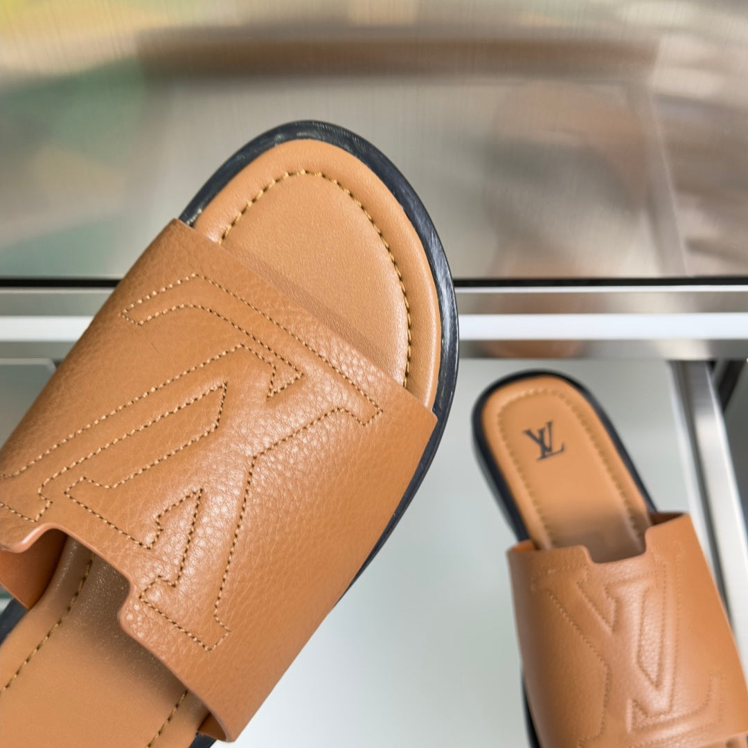 Tan leather slide sandal with patterned LV monogram on strap