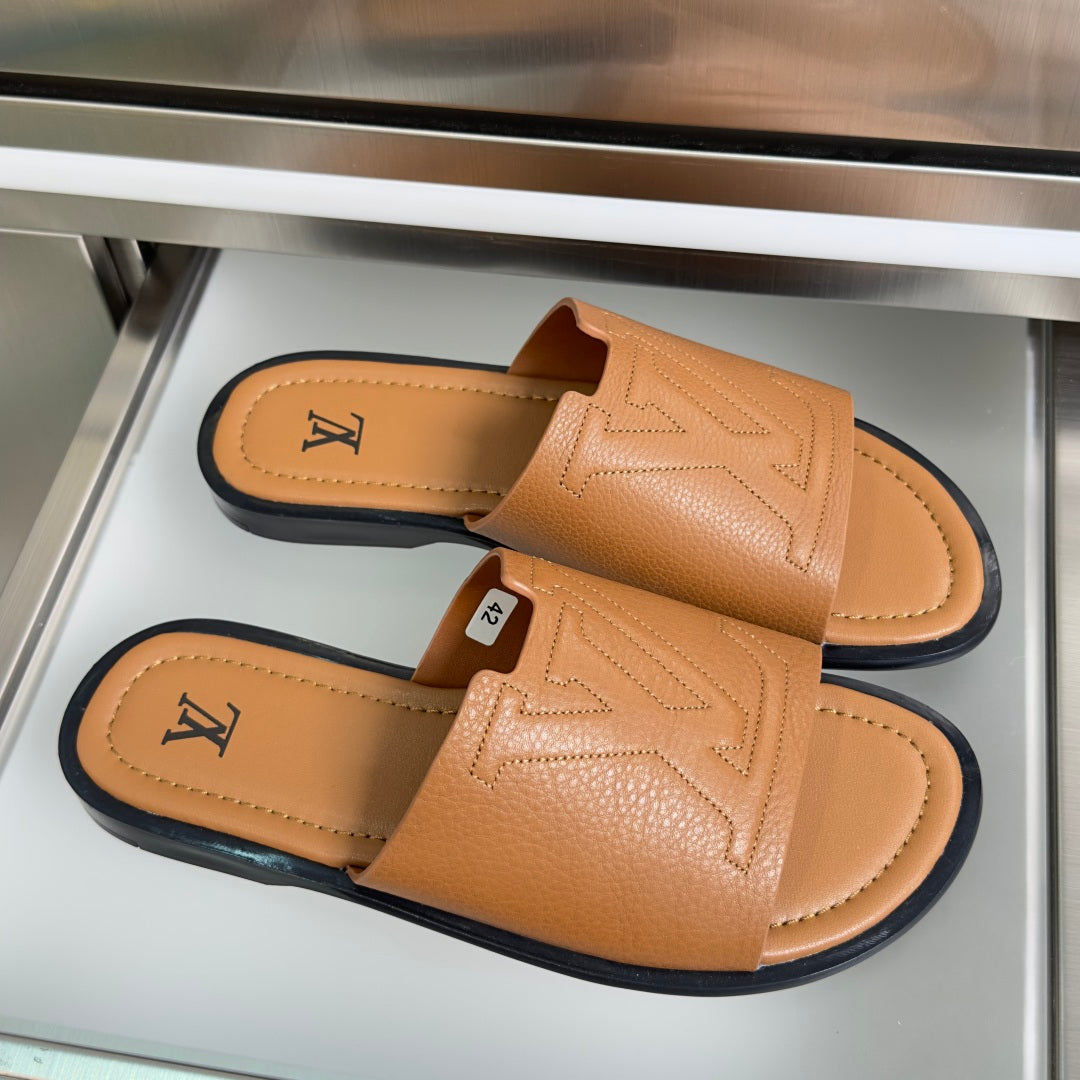 Tan leather slide sandals with wide strap and embossed LV on footbed