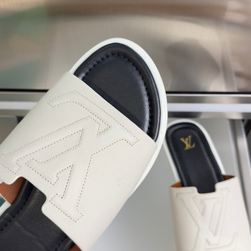 Louis Vuitton slide sandal strap close-up, white leather with embossed pattern