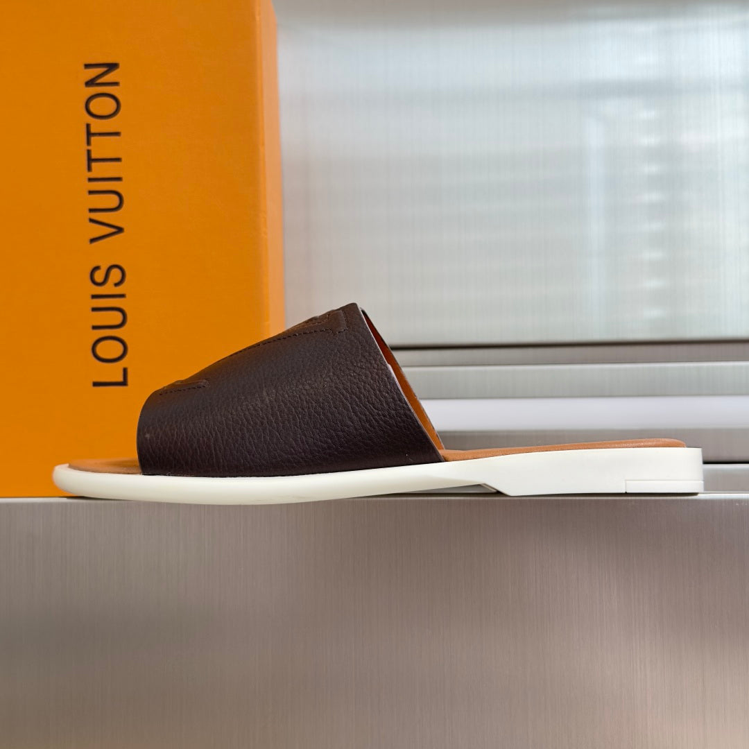 Dark brown leather slide sandal with wide strap and white rubber sole