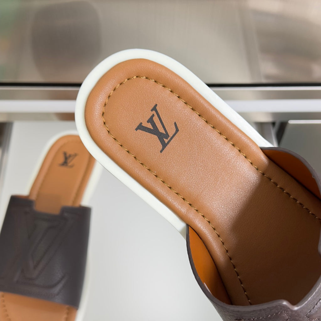 Dark brown leather slide sandal strap with Louis Vuitton monogram on tan insole
