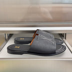 Gray leather slide sandals with wide V-shaped straps and gold LV logo