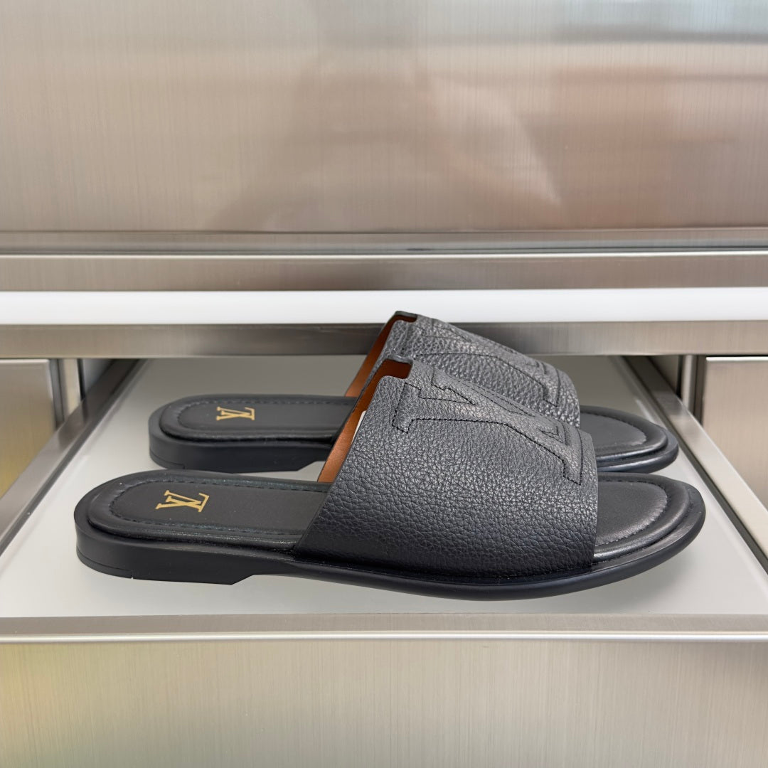 Gray leather slide sandals with wide V-shaped straps and gold LV logo