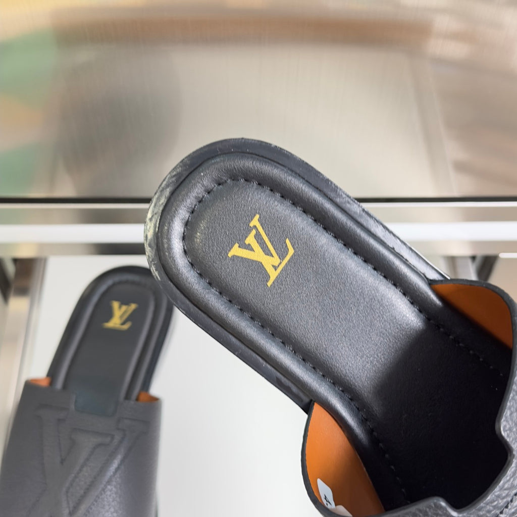 Gray leather slide sandal with gold LV logo on footbed and tan edge accents