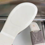 Louis Vuitton suede slide sandal outsole with embossed branding on footbed