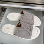 Louis Vuitton suede slide sandals with white lining and gold LV emblem on strap