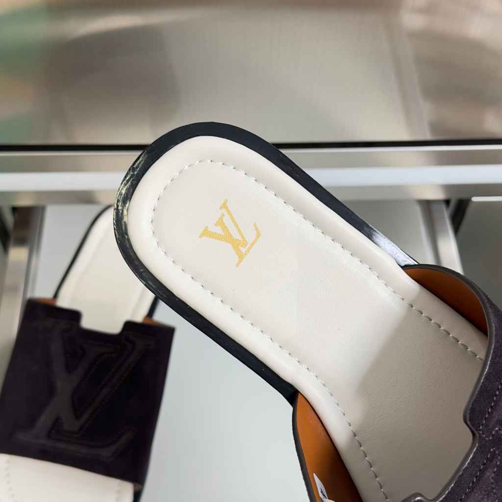 Suede slide sandal strap detail with Louis Vuitton monogram on white footbed