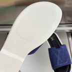 White outsole of blue suede Louis Vuitton slide sandal with traction tread